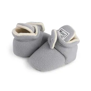 Detailed view of grey fleece baby winter booties featuring a soft fleece texture