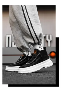 Close-up side view of men's black high-top platform sneakers with thick white soles