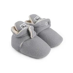 Detailed macro view of grey fleece baby booties with soft plush lining for winter.
