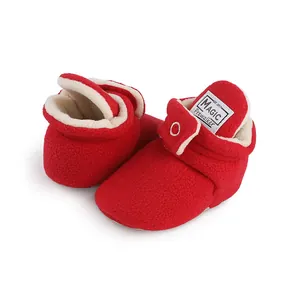 Close-up of red fleece baby prewalker shoes with warm sherpa lining and velcro strap.