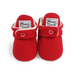 Red fleece baby boots with warm white lining and adjustable Velcro straps