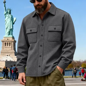 Heavyweight grey outdoor workwear jacket worn by a man at the Statue of Liberty