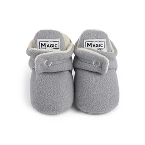 Close-up of cozy gray fleece baby pre-walker shoes with soft warm lining for winter.