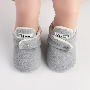 Close-up of grey fleece baby winter boots with soft plush lining and brand label