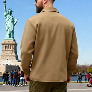 Back view of a heavyweight men's khaki cargo jacket in an outdoor park setting