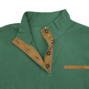 Detail of green corduroy sweatshirt showing stand collar and button texture