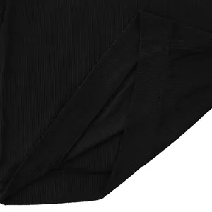Close-up of black corduroy fabric texture and hem stitching on men's sweatshirt