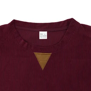 Close-up detail of a men's maroon corduroy sweatshirt neckline with size tag
