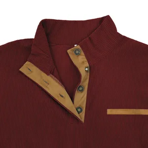 Close-up of men's burgundy corduroy jacket with camel suede stand collar detail