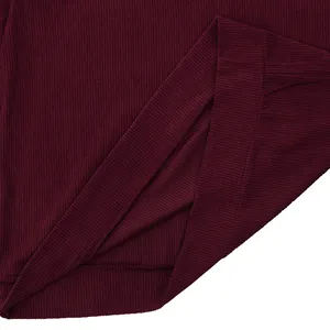 Close-up detail of burgundy corduroy sweatshirt hem showing exquisite ribbed texture