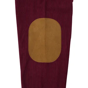 Close-up detail of a burgundy corduroy sweatshirt featuring a contrast tan oval elbow patch.