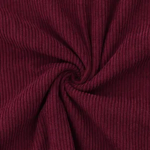 Close-up detail of soft burgundy ribbed corduroy fabric texture for men's sweatshirt