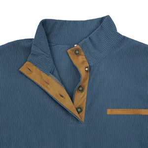Macro view of blue corduroy sweatshirt with brown suede-trimmed collar and metal buttons