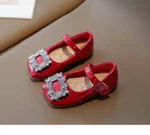 Red patent leather girl's Mary Jane shoes with sparkling rhinestone buckle