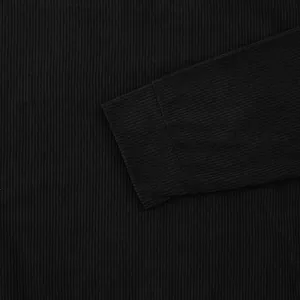 Macro view of black corduroy fabric texture and cuff on men's long sleeve t-shirt
