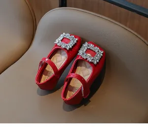 Red patent leather Mary Jane shoes with square rhinestone buckles for girls.