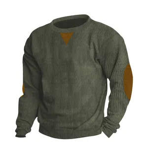 Macro detail of men's olive green corduroy sweatshirt showing texture and elbow patches detail.