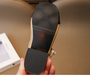 Detailed view of non-slip rubber sole on girls' patent leather Mary Jane sandals