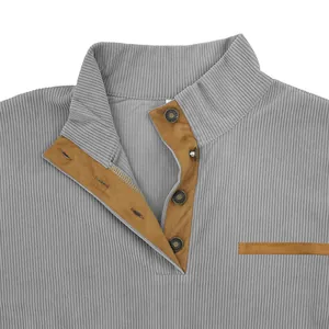 Detail view of men's gray corduroy stand collar sweatshirt with brown trim and snap buttons
