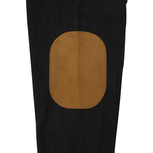 Detailed macro view of black corduroy long-sleeve shirt with brown suede elbow patch