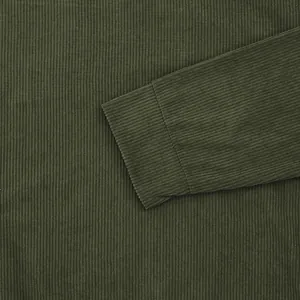 Macro view of olive green corduroy sweatshirt sleeve cuff and ribbed fabric texture