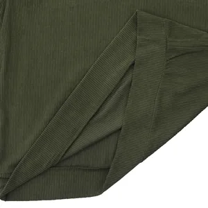 Close-up detail of dark green corduroy fabric on a men's long-sleeve sweatshirt