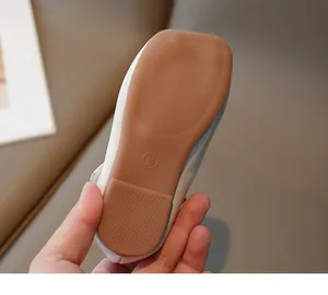 Detailed close-up view of the non-slip brown rubber sole on children's princess shoes