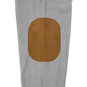 Close-up of brown elbow patch on gray corduroy sweatshirt fabric