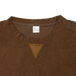 Detail of brown corduroy sweatshirt neckline showing ribbed collar and size tag