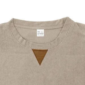 Detail of corduroy sweatshirt collar with decorative triangular patch and size tag