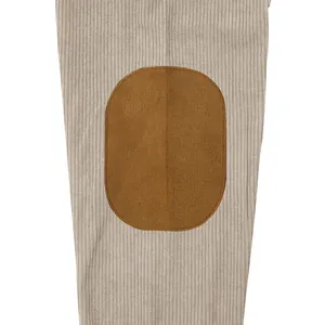 Detail view of a corduroy sweatshirt sleeve featuring a classic brown elbow patch.