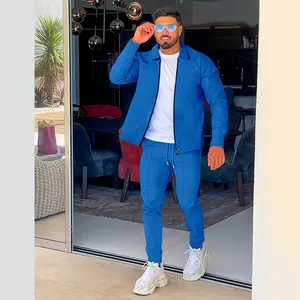Men's bright blue waffle knit tracksuit set with zipper cardigan and matching pants.