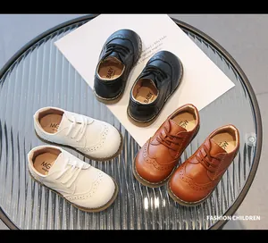 Classic children's brogue shoes in black, white, and brown soft leather for formal wear