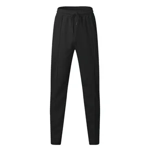 Detailed view of men's black waffle knit joggers featuring pintuck seams and drawstring waist.
