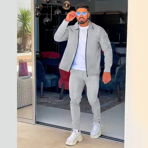 Full body detail of men's grey waffle knit tracksuit set with zipper jacket and pants