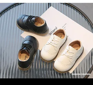 Detailed view of black and white breathable soft leather brogue shoes for children