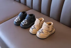 Detailed view of quilted baby winter boots with star patches and warm plush lining