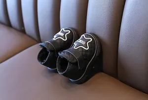 Detailed view of black quilted baby snow boots with warm fleece lining.