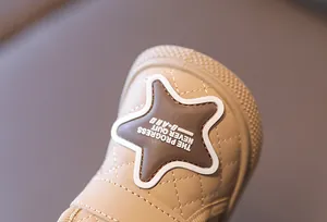 Close-up of star patch and quilted texture on toddler winter snow boots.