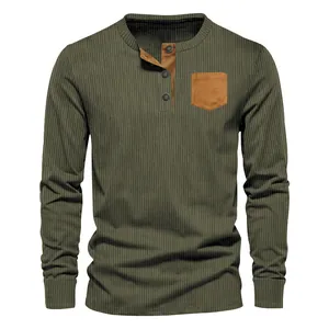 Close-up of men's olive green corduroy Henley shirt with brown patch pocket detail.