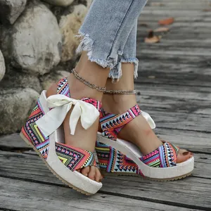 Close-up of ethnic style wedge sandals with vibrant geometric prints and bow detail