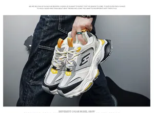 Detailed view of stylish white and yellow chunky sneakers with thick platform soles.