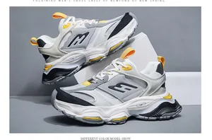 Detailed view of trendy chunky dad sneakers with thick soles in grey and yellow.