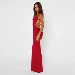 Side profile detail of a red backless evening dress featuring a large back bow