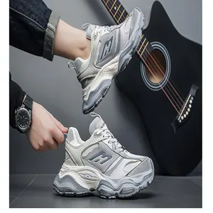 Men's chunky grey platform sneakers with thick soles and lifestyle guitar background