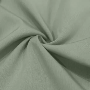 Macro-detail van saliegroene stoftextuur voor casual herenbroeken van hoge kwaliteit