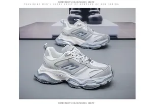 Detailed side view of men's chunky dad sneakers with thick soles in grey and white