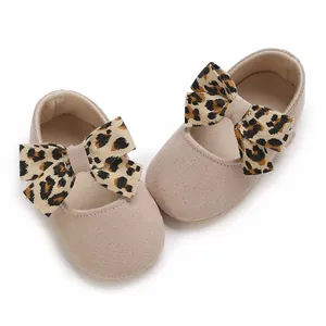 Detail shot of soft-sole baby girl princess shoes with cute leopard print bows