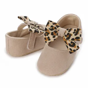 Detail view of baby girl's soft sole walking shoes featuring a leopard print bow