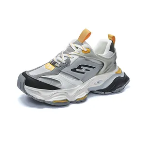 Chunky vintage platform sneakers for men in grey and yellow with mesh and leather upper.
